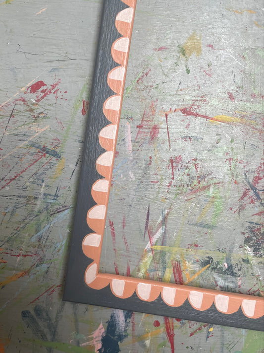 hand-painted frame – orange scallops on black
